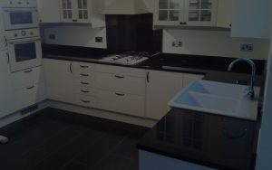 Contemporary kitchen finished with Star Galaxy granite worktops with full-height hob splash back