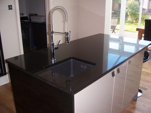 Kitchen island in Star Galaxy granite with an under mounted sink, templated, manufactured and fitted by Millstone Designs