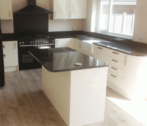 Contemporary kitchen finished with Star Galaxy granite worktops with full-height hob splash back